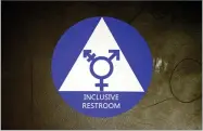  ?? AP PHOTO BY ELAINE THOMPSON ?? In this May 17 file photo, a new sticker designates a gender neutral bathroom at Nathan Hale high school in Seattle.