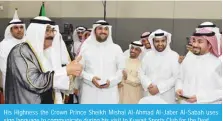  ?? ?? His Highness the Crown Prince Sheikh Mishal Al-Ahmad Al-Jaber Al-Sabah uses sign language to communicat­e during his visit to Kuwait Sports Club for the Deaf.