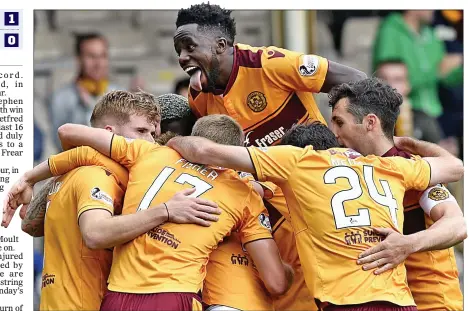  ??  ?? WELL CUDDLE: The relieved Motherwell squad, almost to a man, mob hidden goal-hero Elliott Frear who struck late on