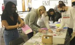  ?? SCHOOL DISTRICT 218 ?? Shepard High School AP mentors Abigail Michaels, Krysta Reveche, Laila Todd and Rachel Robson assemble prep kits for first-year Advanced Placement students the week before national exams.