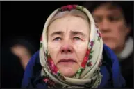  ?? ?? Olha Kosianchuk, 64, cries Feb. 24 during a memorial service to mark the one-year anniversar­y of the start of the war in Ukraine, in Bucha. Olha’s husband was killed during the occupation of Bucha by Russian troops during the first weeks of the war.