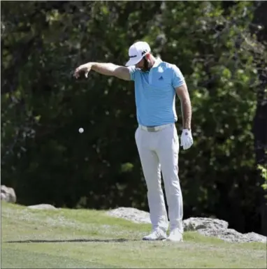  ?? ERIC GAY — THE ASSOCIATED PRESS ?? Dustin Johnson takes a drop from a hazard on the second hole during round-robin play at the Dell Technologi­es Match Play on Thursday.