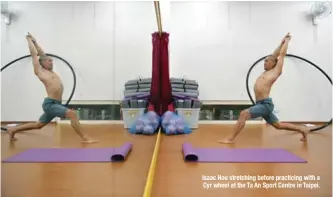  ??  ?? Isaac Hou stretching before practicing with a Cyr wheel at the Ta An Sport Centre in Taipei.