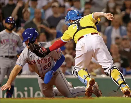  ?? Stuart caHill pHotoS / Herald Staff ?? TOO AGGRESSIVE: Red Sox catcher Christian Vazquez, right, tags out Mets baserunner Pete Alonso at home plate during the fourth inning on Tuesday night at Fenway Park. Below, Kiké Hernandez, who gunned down Alonso, celebrates after scoring on a Xander Bogaerts’ two-run single in the sixth inning.