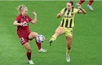  ?? PHOTOSPORT ?? Mackenzie Barry of Wellington Phoenix, right, in action against Adelaide United’s Fiona Worts.