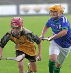  ??  ?? Charlie O’Sullivan (Kilrush) races away from Alex Breen (Barntown).