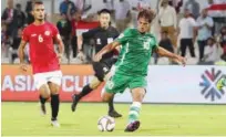  ??  ?? Iraq’s Mohanad Ali Kadhim Alshammari (centre) atttempts a shot during their Group D match against Yemen at the Sharjah Stadium on Saturday.