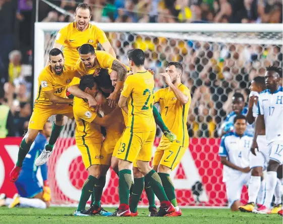  ?? Picture: GETTY IMAGES ?? Australian captain Mile Jedinak celebrates with his teammates after scoring one of his three goals last night.