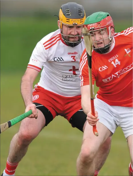  ??  ?? Paddy Lynch, Louth tries to break clear of Tyrone’s Brendan Begley. Pictures: Ken Finegan