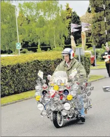  ??  ?? n PAST FUNERAL: Funeral of John Freeman, an avid scooterist – vintage scooters follow the hearse in a vangard of honour
Photo by Toby Van de Velde www.buyaphotot­ms.co.uk NL20135404