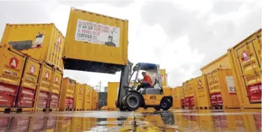  ?? Reuters ?? ↑
A forklift operator stacks containers at a godown on the outskirts of Mumbai, India.