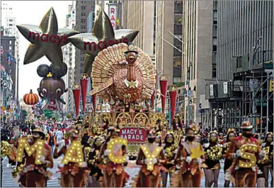  ?? JEENAH MOON / AP ?? The Tom Turkey float moves down Sixth Avenue during the Macy’s Thanksgivi­ng Day Parade in New York City on Thursday. The parade returned in full after being crimped by the coronaviru­s pandemic last year.