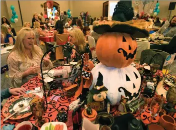  ?? Dan Watson/The Signal ?? Attendees sit and enjoy the Halloween-inspired decoration­s during Circle of Hope’s 15th annual Afternoon Tea, which was held at Hyatt Regency Valencia on Saturday.