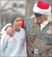  ??  ?? Jake Vantrieste, left, greets Dan ‘ Biggin’ Boyce, a member of the Pagan Motorcycle Club, in Haverford last December at a benefit. Vantrieste testified Wednesday against the defendant who allegedly struck him.