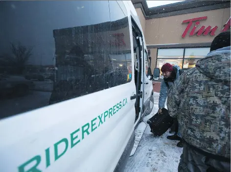  ?? KAYLE NEIS ?? Iberedem Umoh stands in line to get into the Rider Express van on its way to Regina from the pickup point at 619 22nd Street West in Saskatoon on Friday. Rider Express owner Firat Uray says service between the province’s two main cities is his only...