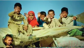  ??  ?? TORKHAM, AFGHANISTA­N: In this photograph taken on September 7, 2016, repatriate­d Afghan refugee children wave as they travel in a packed vehicle preparing to cross the border into Afghanista­n, at the Torkham crossing point in Pakistan’s tribal Khyber...