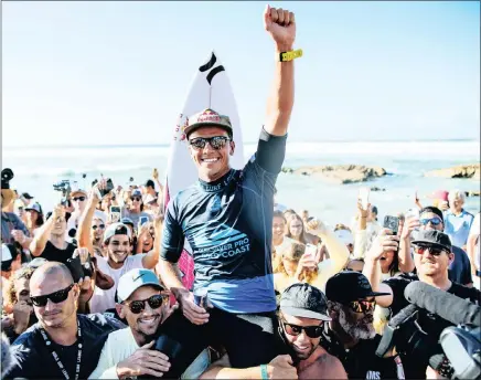  ??  ?? VICTORIOUS: Current world No 1, Australian Julian Wilson, is carried to the winner’s podium on the shoulders of his older brothers, Seb and Bart, after clinching the season opener, the Quiksilver Pro Gold Coast, this week.