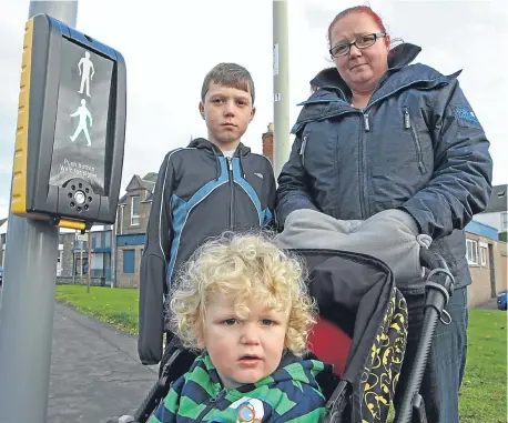  ??  ?? Mandy Laidlaw and her sons Jak and Blake at the crossing where the incident happened.