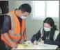  ?? FU MIN / XINHUA ?? Yi Jingxing, a 45-year-old worker, borrows a book on Saturday from the library located at a constructi­on site in Xiang’an district, Xiamen, Fujian province.