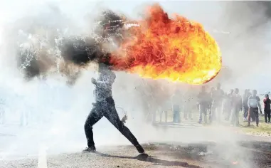  ??  ?? STRIKING: This picture taken by photograph­er Phandulwaz­i Jikelo, of a protester in Grabouw last year, has been selected for the final round of the Andrei Stenin Internatio­nal Press Photo Contest. The competitio­n aims to support young photograph­ers, as...