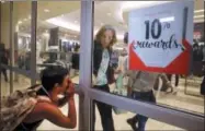  ??  ?? A protester yells as a woman rushes to close the doors to a department store as protesters march through West County Mall in response to a not guilty verdict in the trial of former St. Louis police officer Jason Stockley Saturday, Sept. 16, 2017, in...