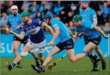  ?? ?? IN HOT PURSUIT: Ross King of Laois is chased down by Dublin duo James Madden and Conor Burke