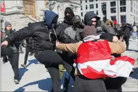  ?? Canadian Press photo ?? Anti-fascists, left, clash with opposing protesters during a demonstrat­ion regarding motion M-103 in Montreal on Saturday.