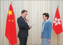  ?? PROVIDED TO CHINA DAILY ?? Eric Chan Kwok-ki, secretary-general of the Committee for Safeguardi­ng National Security of the HKSAR, takes the oath of office on Thursday with Chief Executive Carrie Lam Cheng Yuet-ngor.