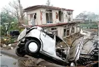  ?? (AP) ?? PORTENT OF THINGS TO COME — A strong wind destroyed a house and a car in Ichihara, Chiba, near Tokyo, ahead of the forecast landfall of Typhoon Hagibis on October 12, 2019, the worst in six decades.