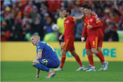  ?? Photograph: Tom Jenkins/The Guardian ?? Ukraine’s Oleksandr Zinchenko sinks to the turf.