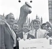  ??  ?? Hood, right, holding card, with MPS Jimmy Dunnachie, left, and Willie Mckelvey, centre, campaignin­g to keep the lochs free of nuclear weapons, 1987