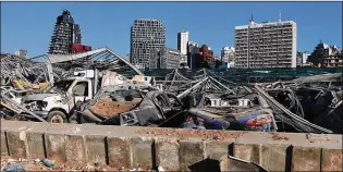  ?? BILAL HUSSEIN / ASSOCIATED PRESS ?? Damaged cars remain Monday at the site of the Aug. 4 explosion that killed more than 180 people, injured thousands and caused widespread destructio­n in the seaport of Beirut, Lebanon. Many Lebanon residents have closed ranks to tend to collective wounds.