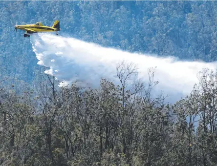  ?? Picture: Nev Madsen ?? AIR ATTACK: Water bombers were called in to fight a large scrub fire on the range.