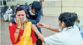  ?? ?? A health worker administer­s a dose of COVID-19 vaccine to a beneficiar­y (File Picture)