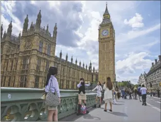  ?? FRANK AUGSTEIN/AP ?? WITH BIG BEN IN THE BACKGROUND, in London on July 6, 2023. tourists take snapshots on Westminste­r Bridge