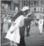  ?? THE ASSOCIATED PRESS ?? In this Aug. 14, 1945 file photo provided by the U.S. Navy, a sailor and a woman kiss in New York’s Times Square, as people celebrate the end of World War II.