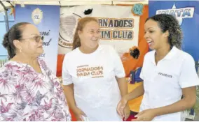  ?? ?? Wendy Lee (centre), Tornadoes Swim Club head coach, engages Diana Tewani (left), director of Tewani Limited; and First Rock’s Group Marketing Manager Sherianne Hart on the final day of the Tornadoes Swim Club Invitation­al meet at the National Aquatic Centre on Sunday.