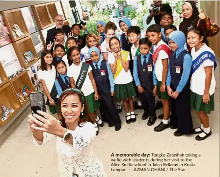  ?? — AZMAN GHANI / The Star ?? A memorable day: Tengku Zatashah taking a wefie with students during her visit to the Alice Smith school in Jalan Bellamy in Kuala Lumpur.