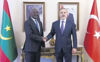  ?? ?? Foreign Minister Hakan Fidan (R) shakes hands with Mauritania­n Foreign Minister Mohamed Salem Ould Merzoug after a meeting, Istanbul, Türkiye, April 21, 2024.