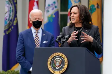  ?? The Associated Press ?? n In this March 12 file photo President Joe Biden listens as Vice President Kamala Harris speaks about the American Rescue Plan, a coronaviru­s relief package, in the Rose Garden of the White House in Washington.