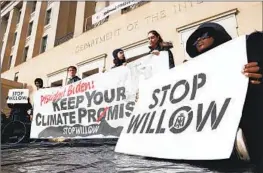  ?? Jemal Countess Getty I mages ?? CLIMATE ACTIVISTS hold a rally urging President Biden to reject the Willow oil- drilling project outside the Interior Department in Washington in November.