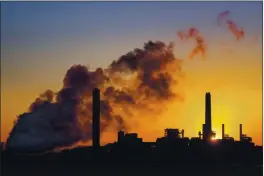  ?? J. DAVID AKE — THE ASSOCIATED PRESS FILE ?? The Dave Johnson coal-fired power plant is silhouette­d against the morning sun in Glenrock, Wyo.