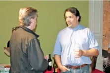  ?? FILE PHOTO BY JEREMY STEWART/ROME NEWS-TRIBUNE VIA AP ?? Republican congressio­nal candidate John Cowan, right, greets supporters in June in Rome, Ga., at an election night party.