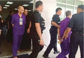  ?? Pic by Avila Geraldine ?? Datu Amirbahar Hushin (left) being led out of the Sabah Courts Complex in Kota Kinabalu yesterday.