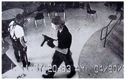  ??  ?? Unimaginab­le: Sue Klebold with young son Dylan, and inset, the gun-toting teen caught on camera at Columbine High School