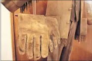  ?? HOKE/ THE OKLAHOMAN] [DOUG ?? Gloves and jacket worn by Matt Damon to play LaBoeuf in the 2010 movie “True Grit” are featured in the National Cowboy & Western Heritage Museum's exhibit.