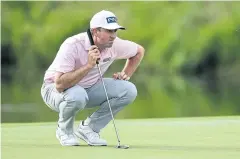  ??  ?? TARGET IN SIGHT: Michael Thompson lines up a putt on the sixth green at the 3M Open on Friday.