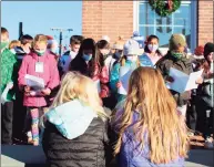  ?? ?? Fifth-graders from Veterans Park Elementary School spread Christmas cheer during a caroling concert in front of Town Hall on Monday in Ridgefield.
