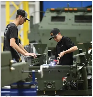 ?? (Arkansas Democrat-Gazette/Staci Vandagriff) ?? Assembly-line operators work on the HIMARS production line at the Lockheed Martin Missiles and Fire Control facility in Camden on Thursday.