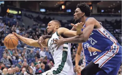  ?? ASSOCIATED PRESS ?? The 76ers’ Joel Embiid fouls the Bucks’ Jabari Parker during the second half Monday at the BMO Harris Bradley Center.